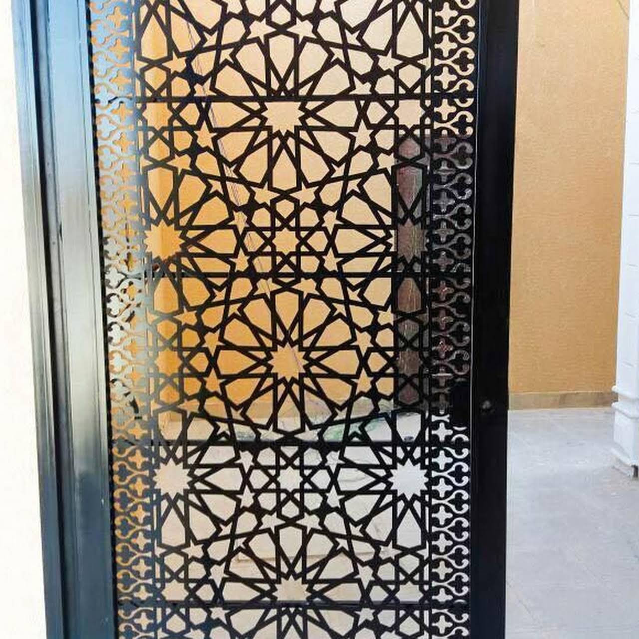 Laser cut metal decorative screen installed on a building in Ghana