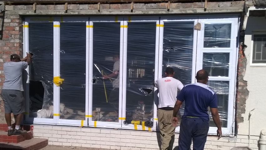 Automatic glass folding door installed by Alucobond Ghana in a commercial property in Ghana